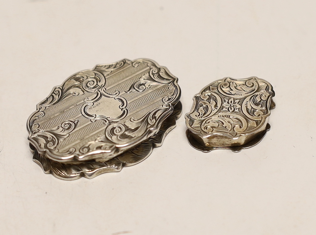 A Victorian engraved silver cartouche shaped vinaigrette, Cronin & Wheeler, Birmingham, 1846, 40mm and other other smaller silver vinaigrette, Francis Clark, Birmingham, 1840.